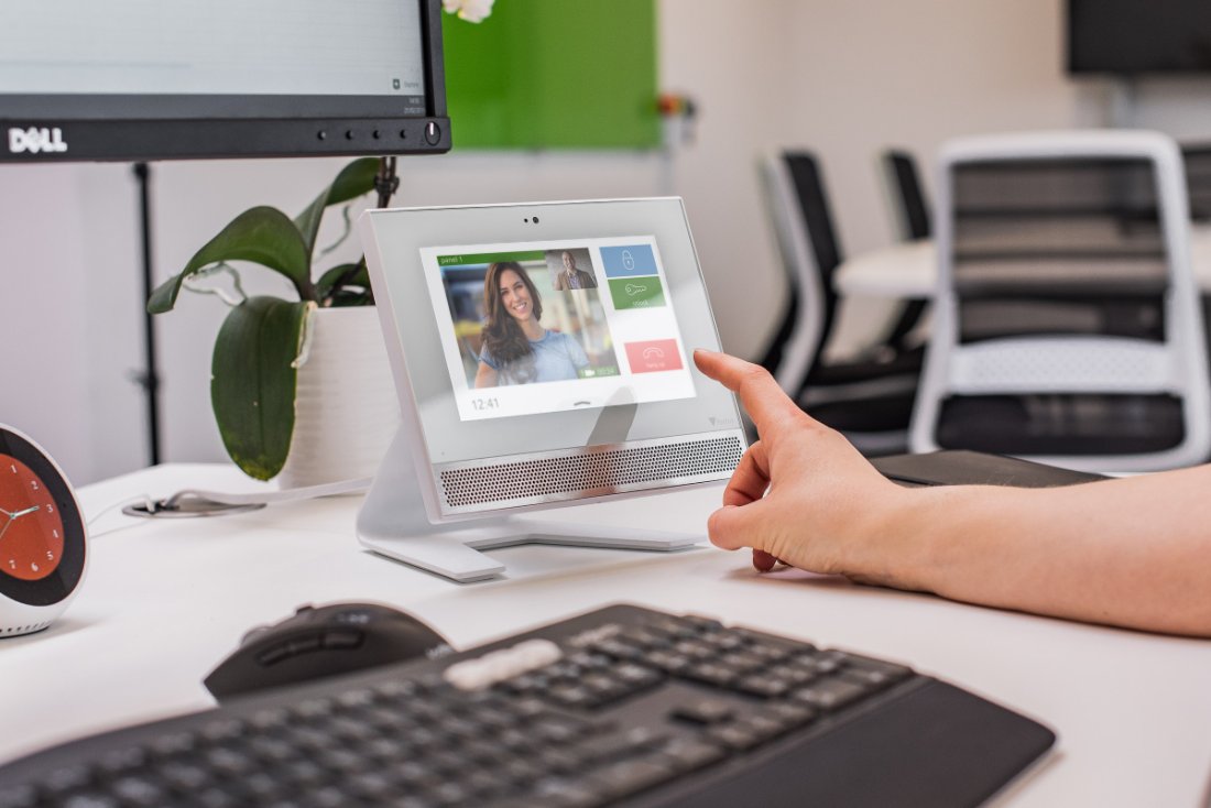 Paxton video entry monitor on a desk being used with one hand